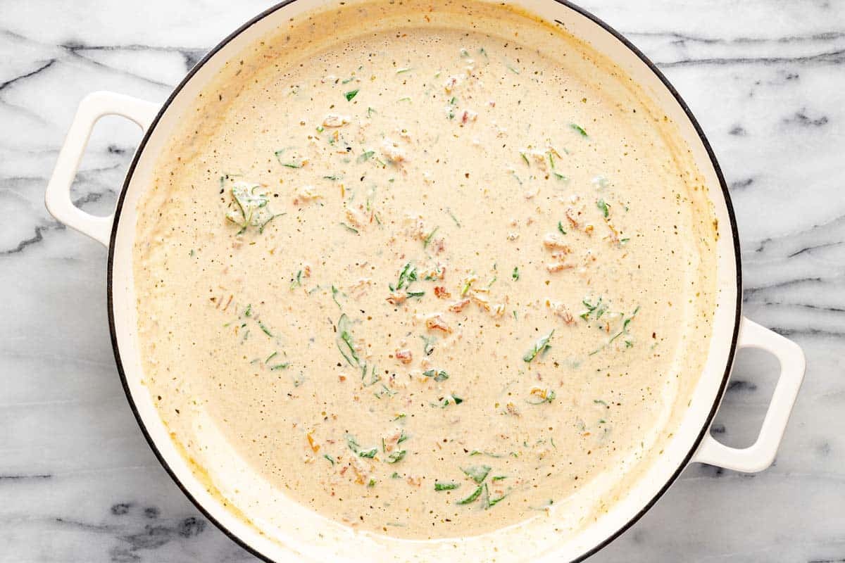 Creamy Tuscan pasta sauce in a large pan. 