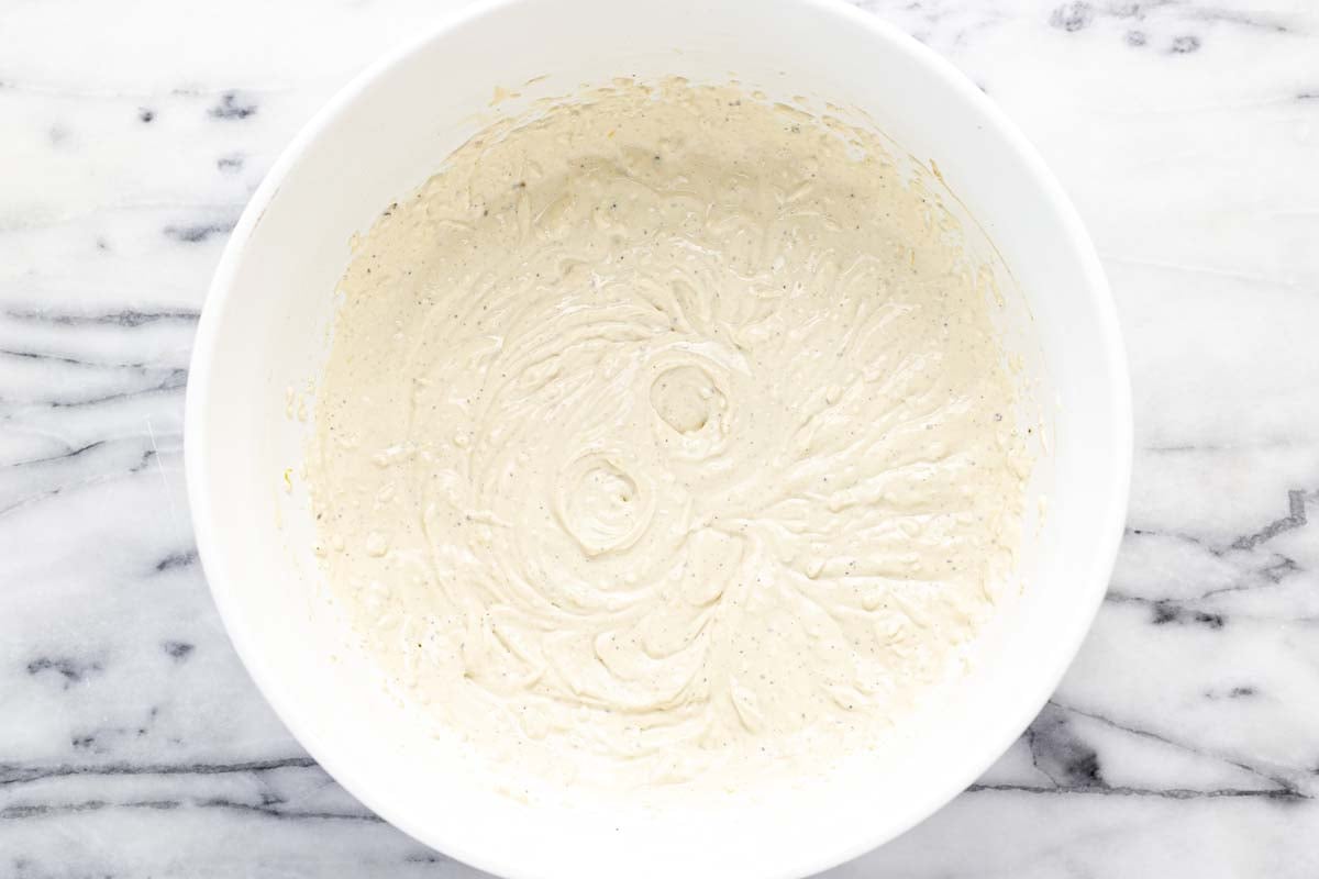 Bowl of creamy ingredients to make Caesar salad dip. 