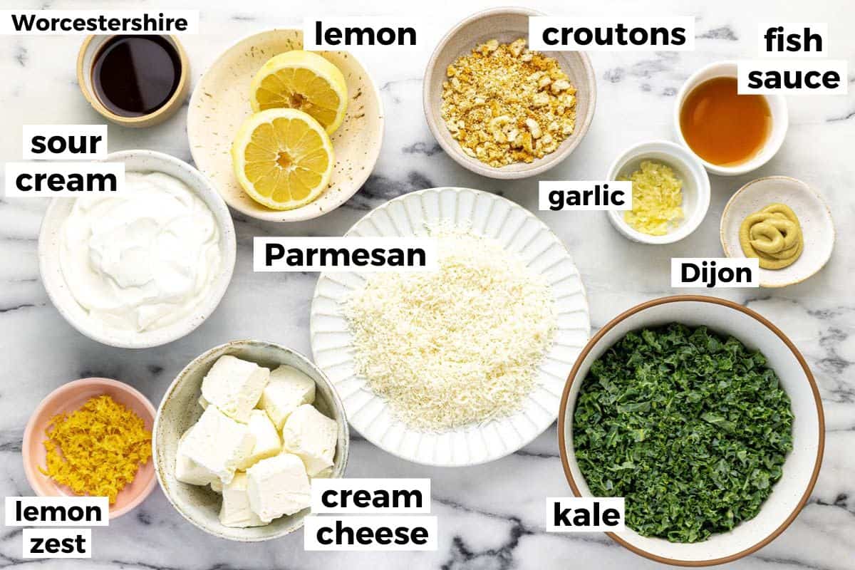 Bowls of ingredients to make creamy Caesar salad dip. 