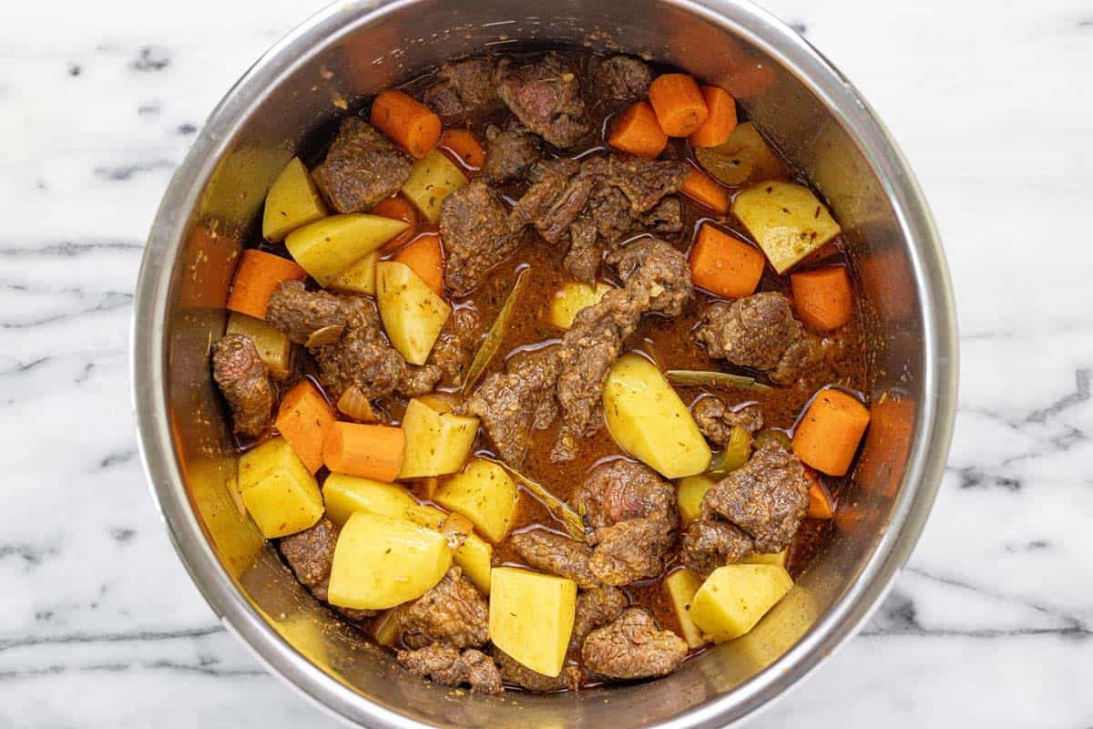 Beef stew ingredients in an instant pot. 