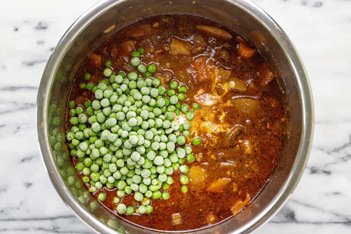 Peas and cornstarch slurry added to beef stew. 