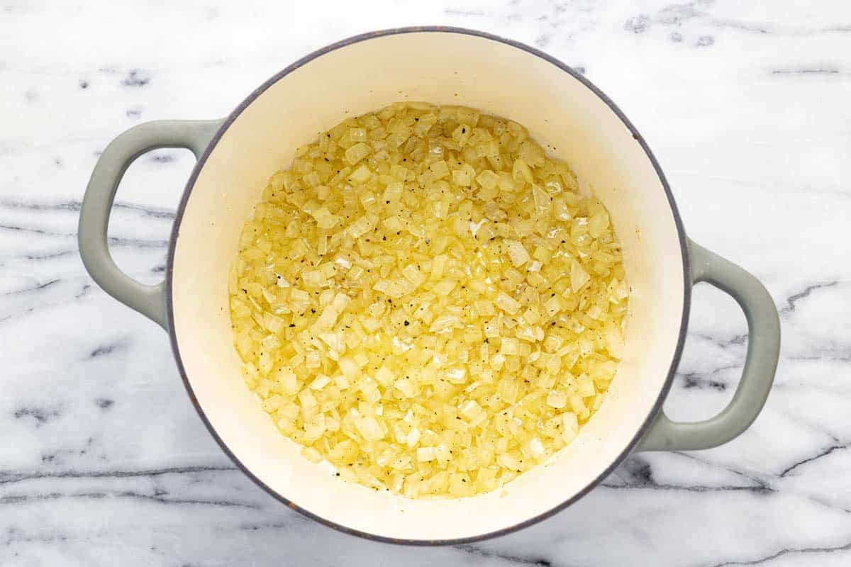 Large pot filled with sauteed onions. 