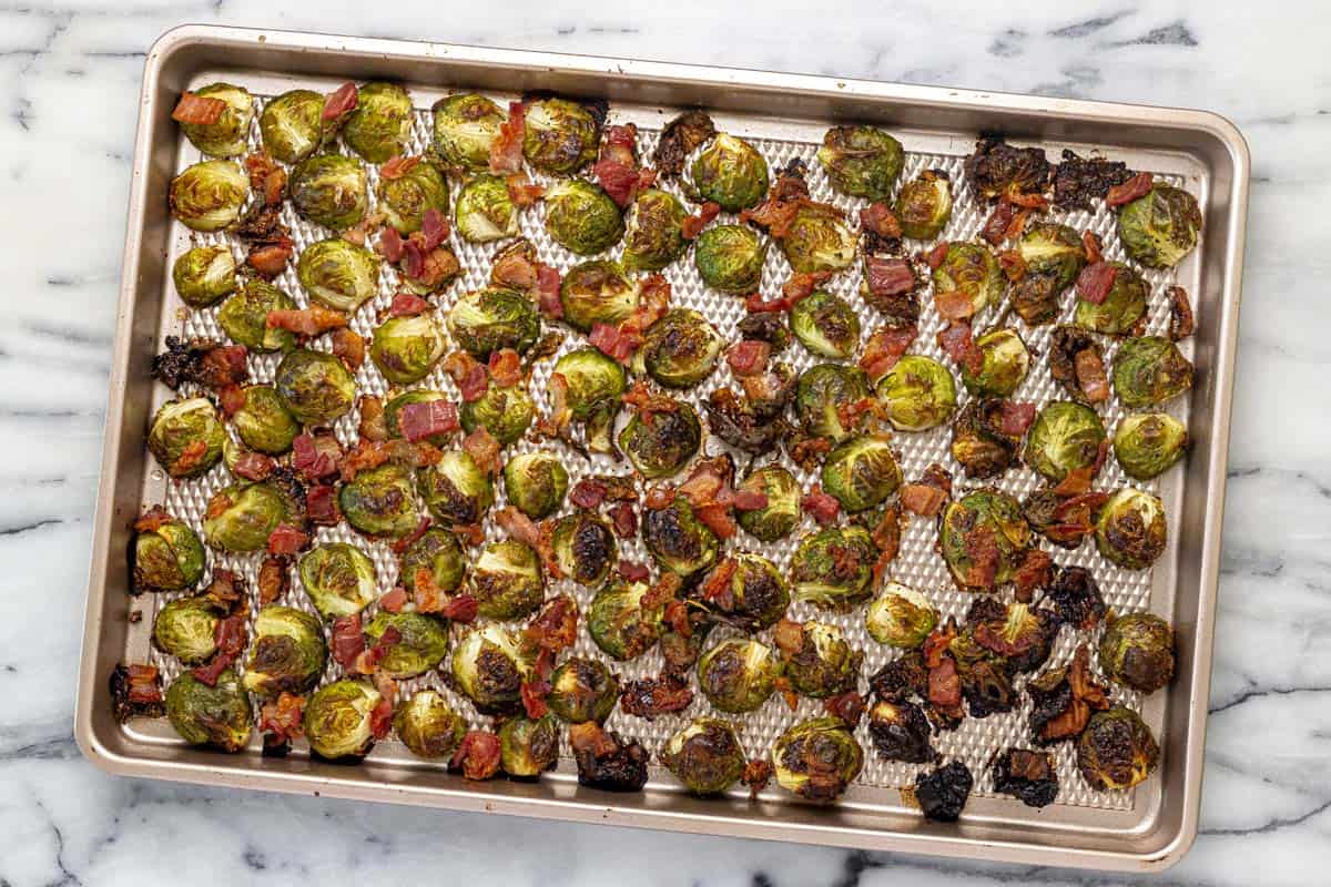 Roasted Brussels sprouts and bacon on a sheet pan.