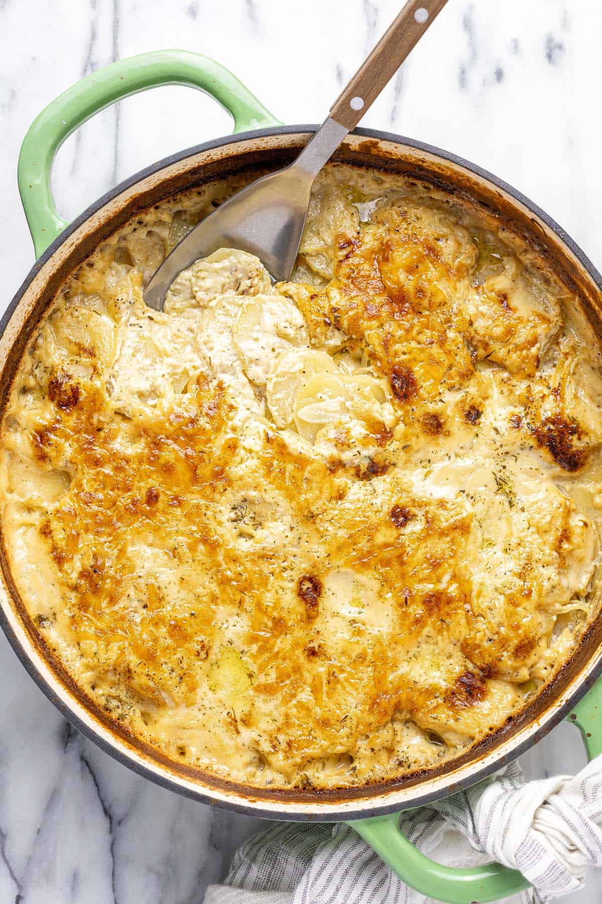 Large pan filled with creamy homemade au gratin potatoes. 