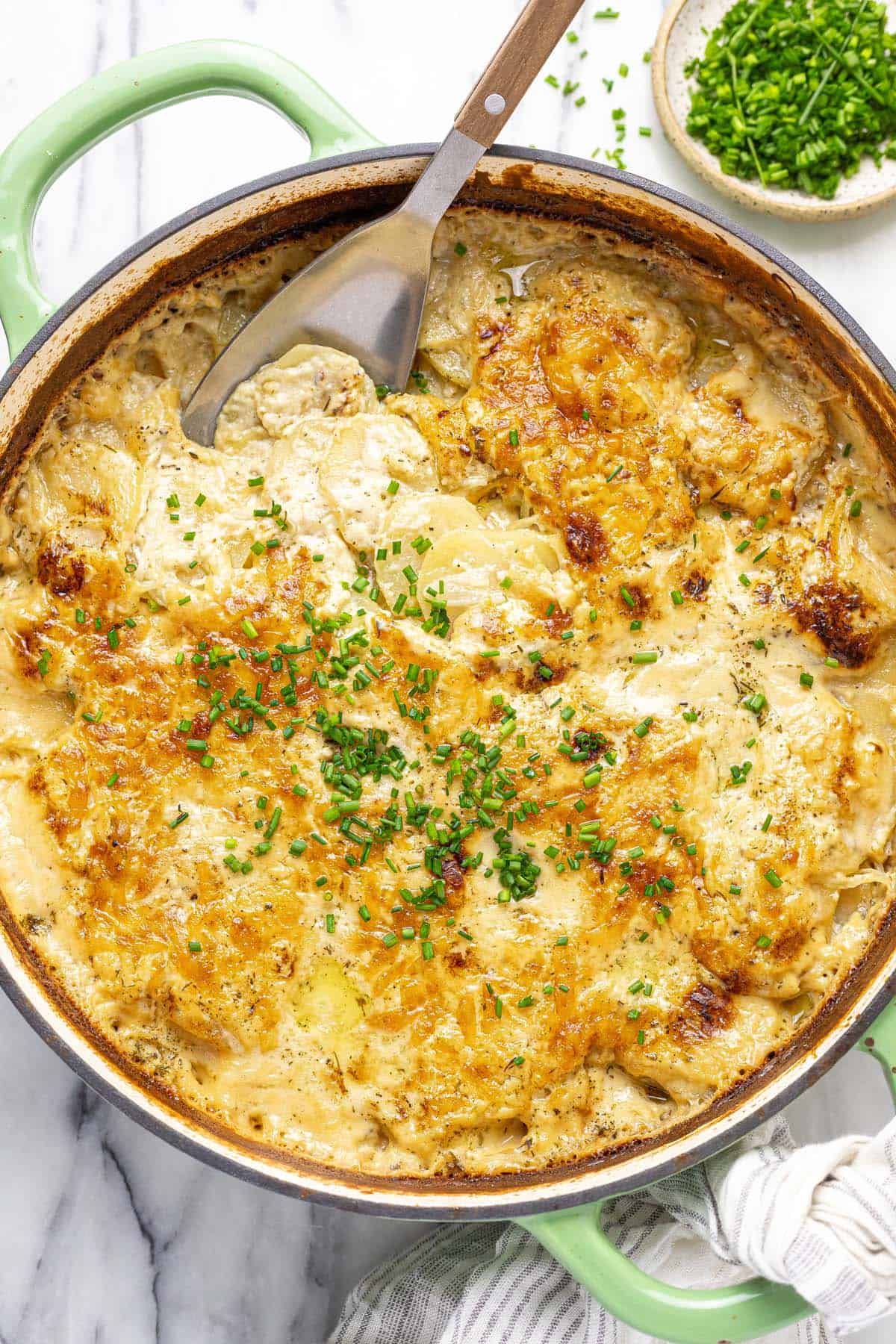 Large pan filled with creamy homemade au gratin potatoes. 