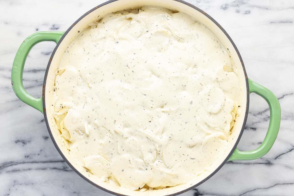 Creamy cheese sauce poured over sliced potatoes and onions. 