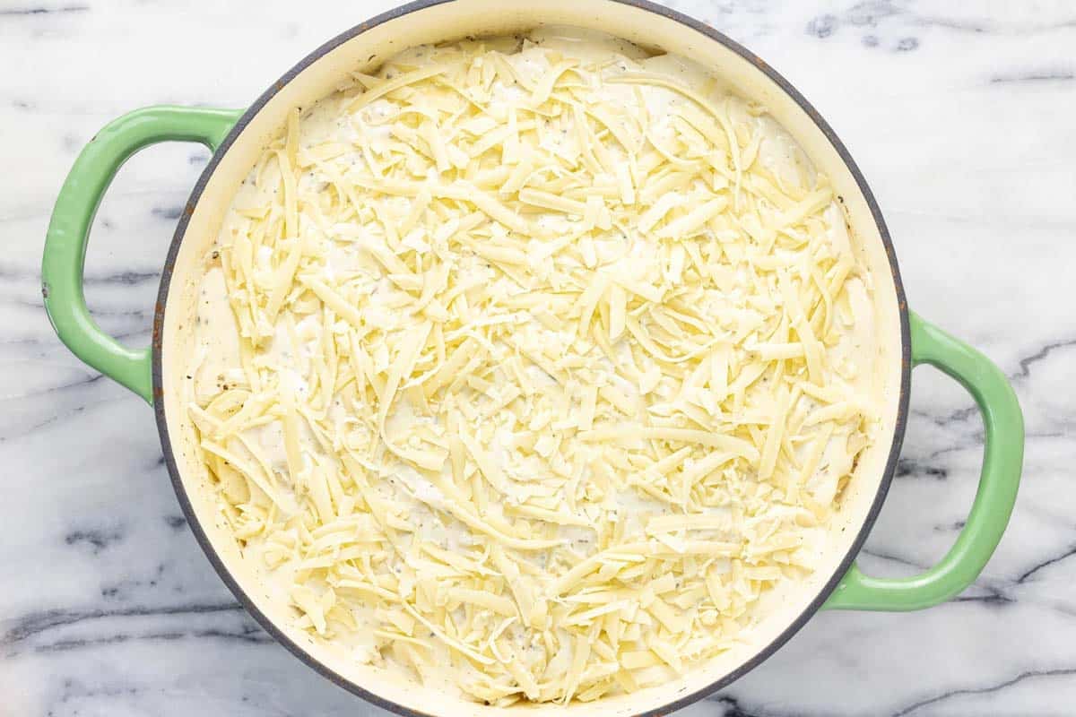 Shredded cheese on top of au gratin potatoes. 