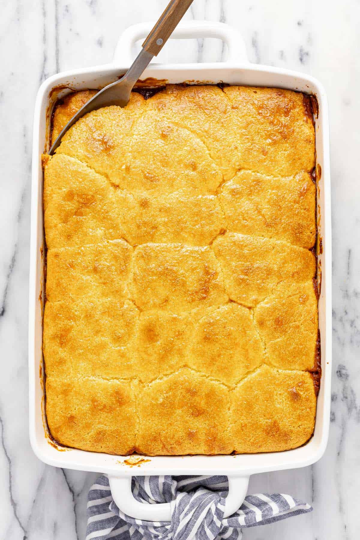 Large baking dish filled with homemade cornbread and chili casserole. 