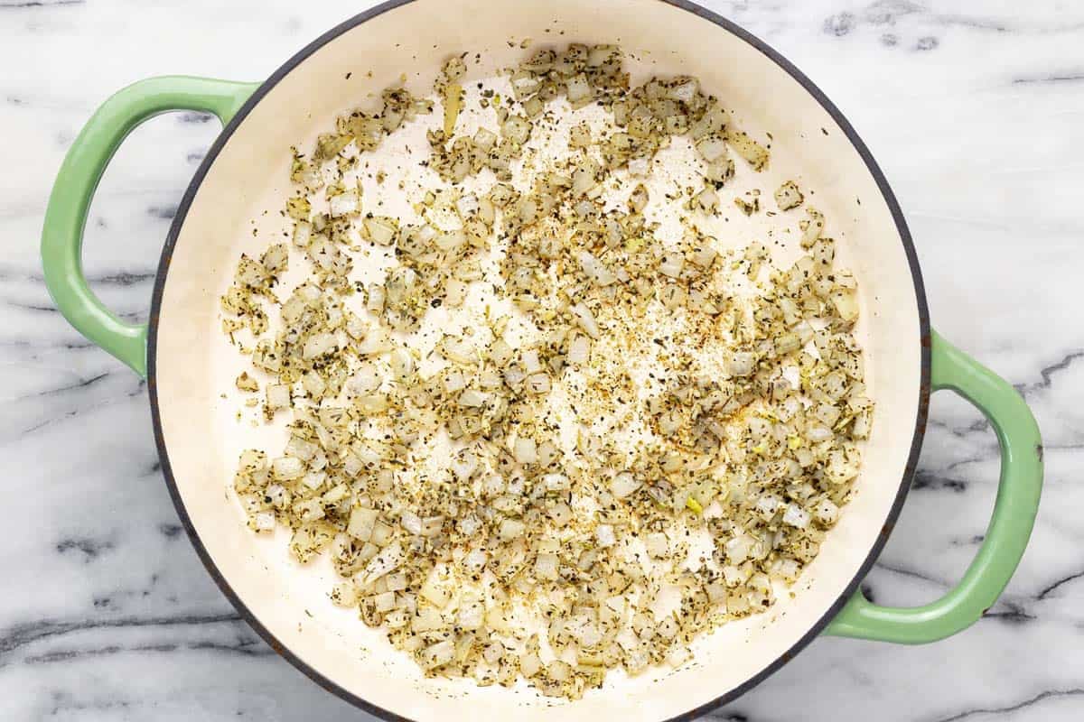 Sauteed onions, garlic, and herbs in a large pan. 