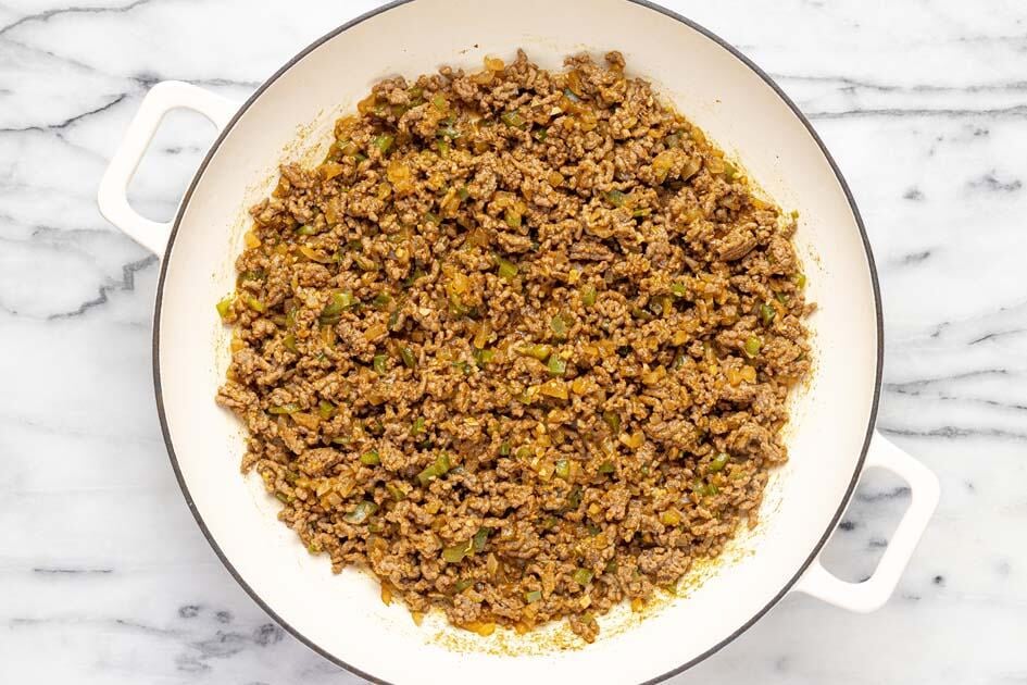 Large pan filled with ground beef and sauteed veggies. 