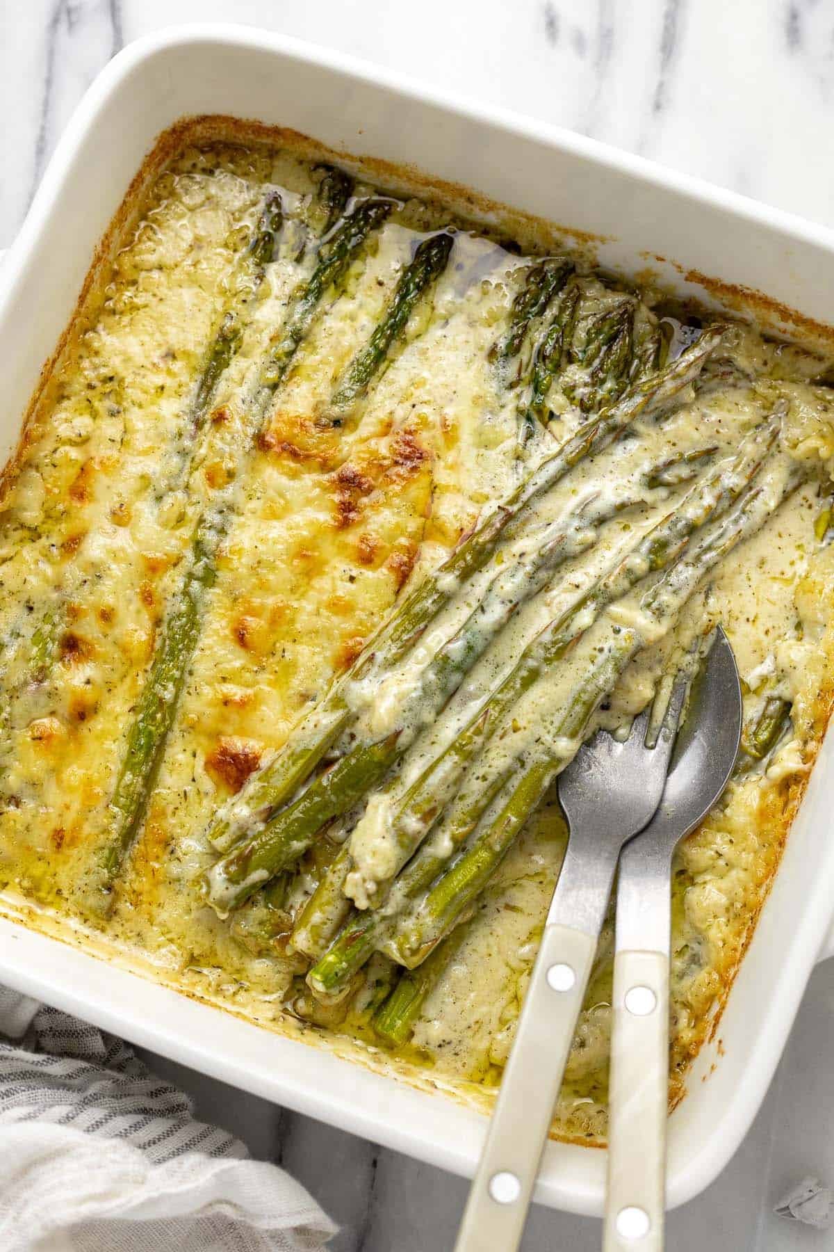 Close up baking dish filled with asparagus au gratin.
