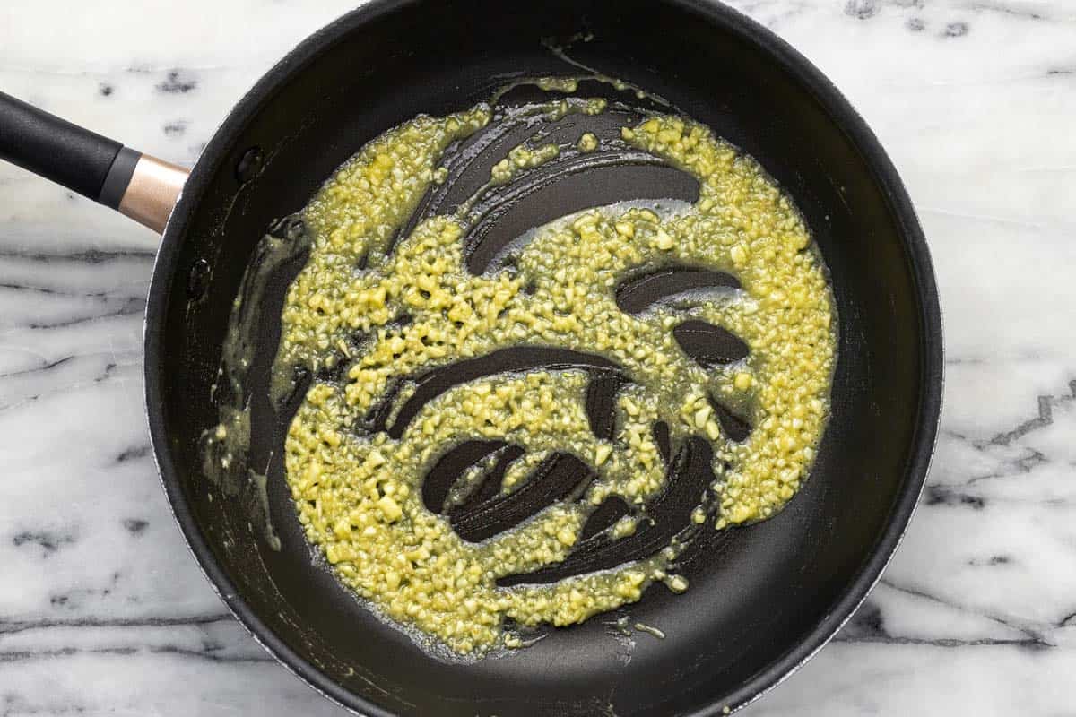 Large pan filled with butter, garlic, herbs, and flour.