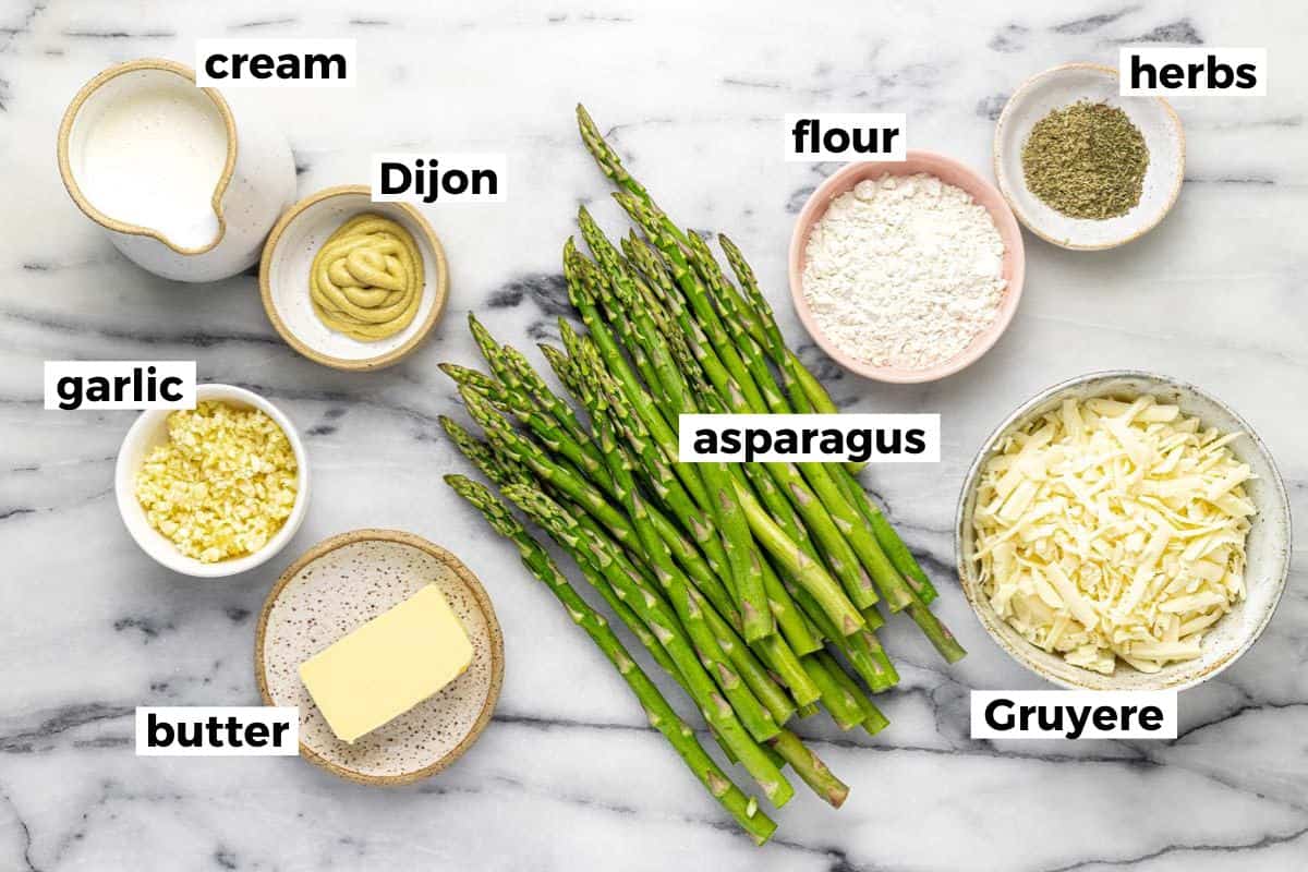 Bowls of ingredients to make au gratin asparagus.