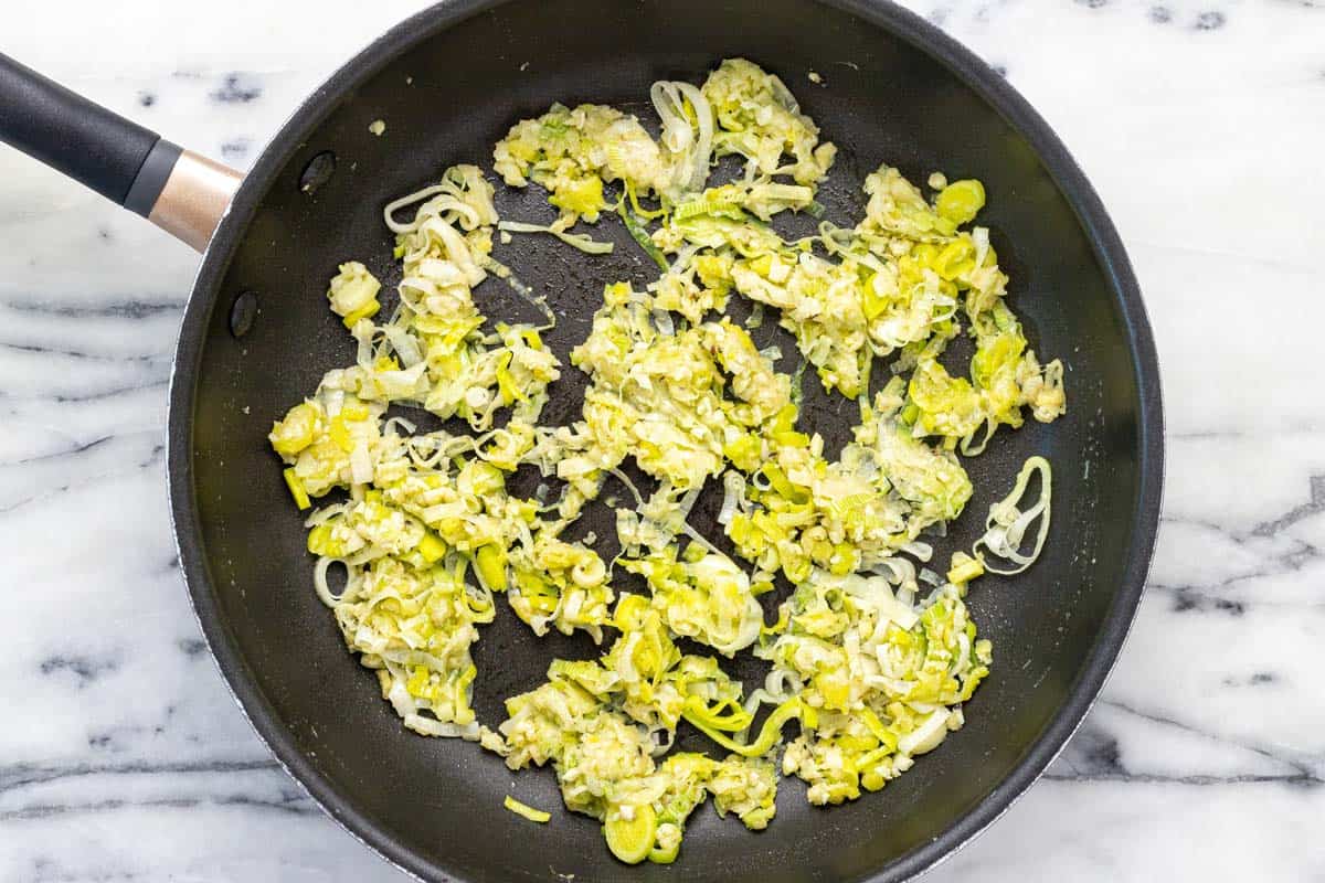 Sauteed leeks in a large pan. 