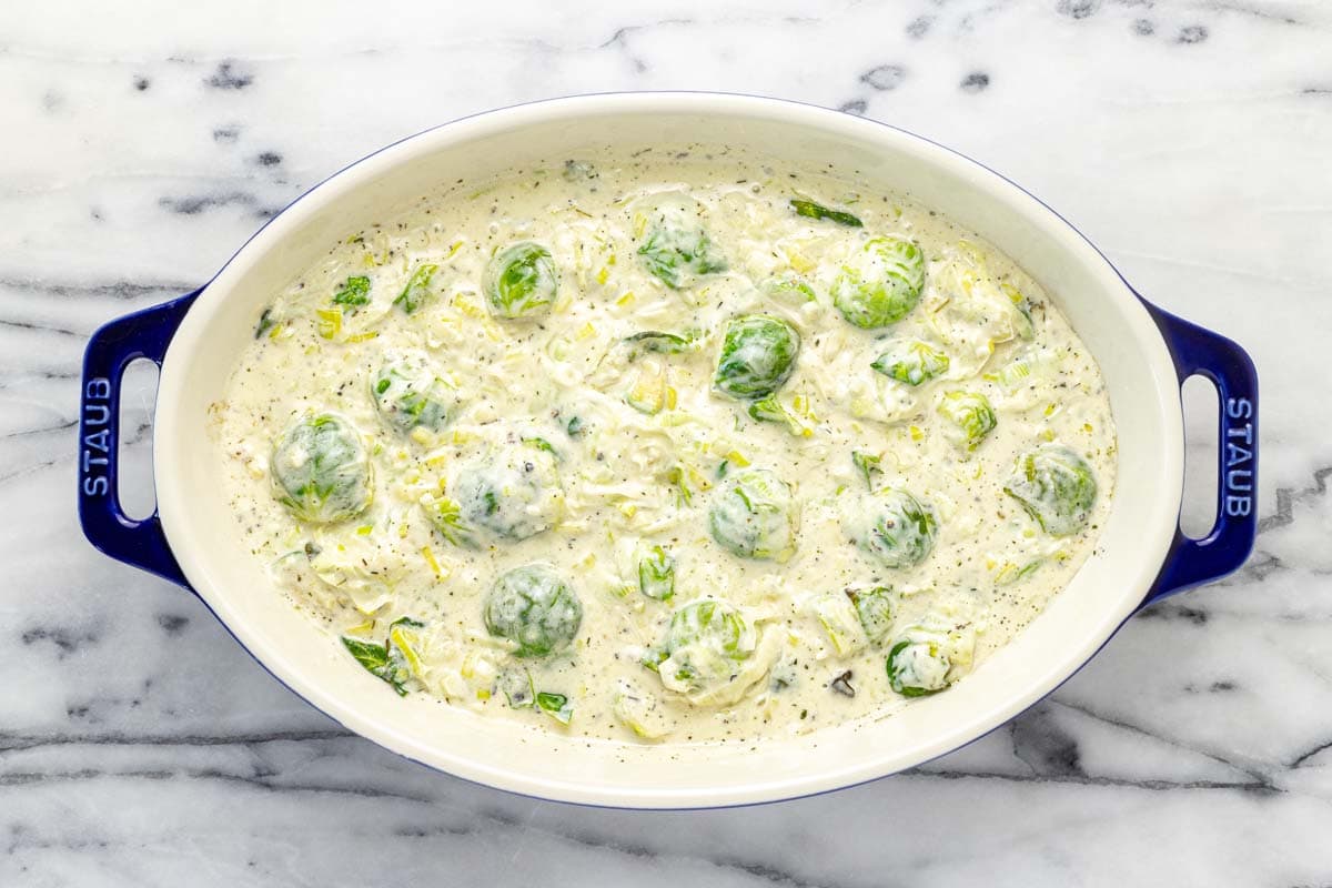 Creamy Brussels sprouts au gratin in a small baking dish. 