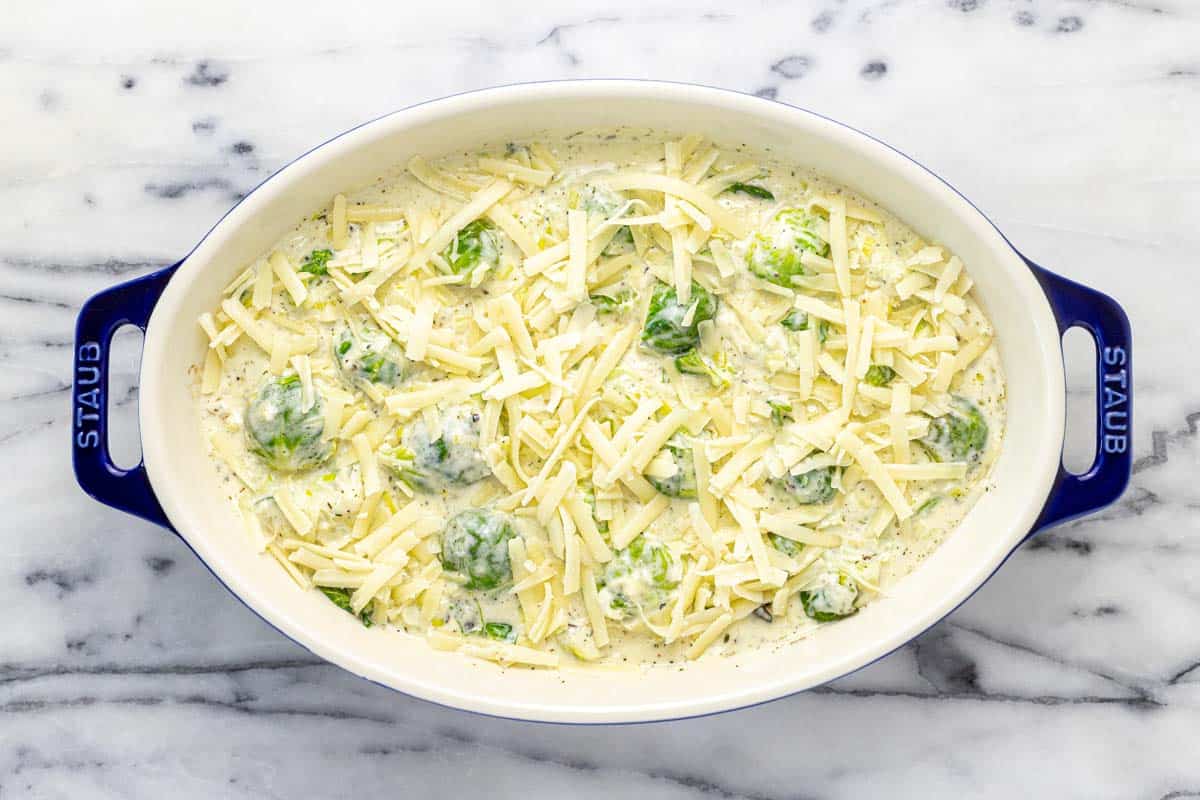 Shredded cheese on top of Brussels sprouts au gratin. 