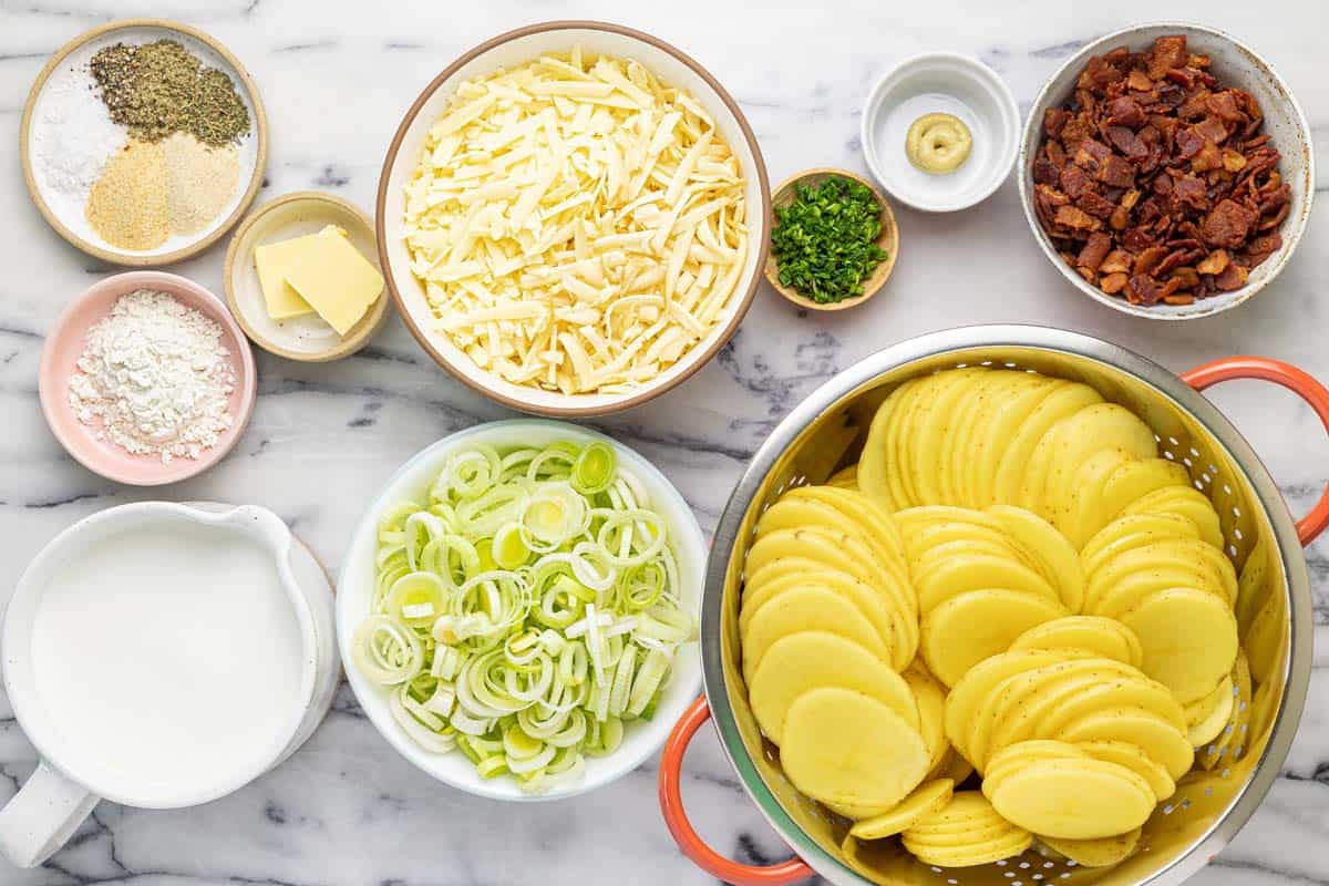 Bowls of ingredients to make bacon leek au gratin potatoes. 