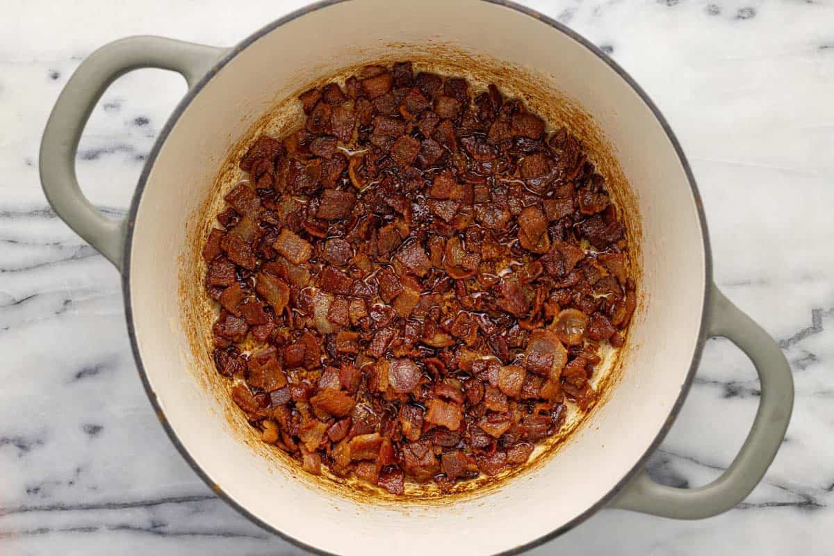 Large pot filled with crispy diced bacon. 