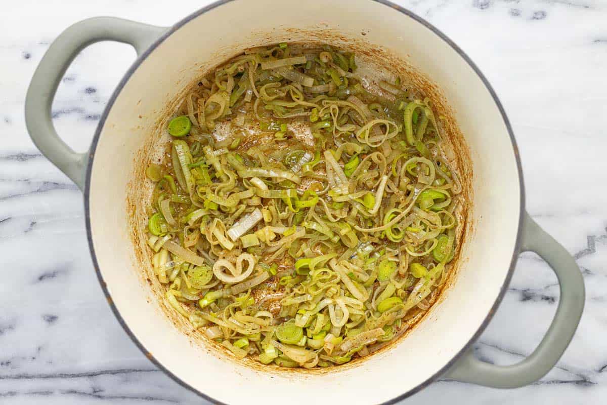 Large pot with sauteed leeks. 