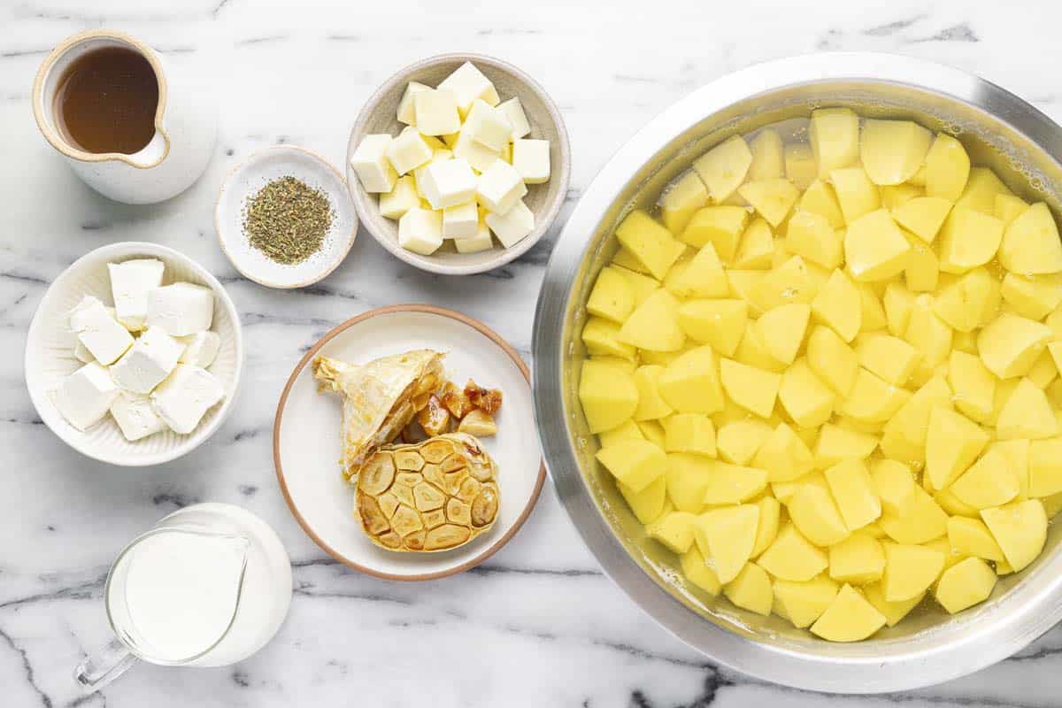 Bowls of ingredients to make slow cooker mashed potatoes. 