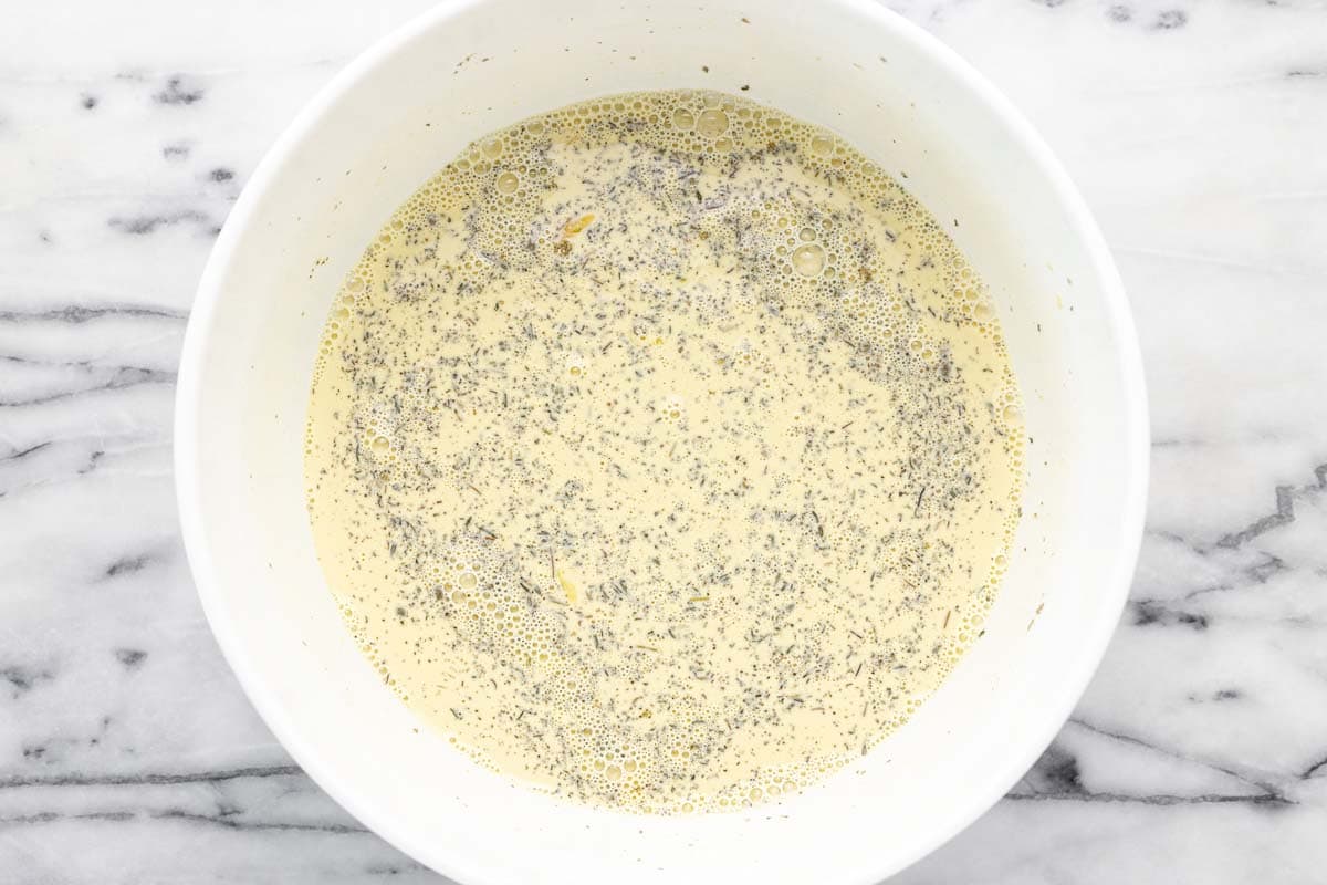 Bowl of egg custard for a ham and cheese bake.