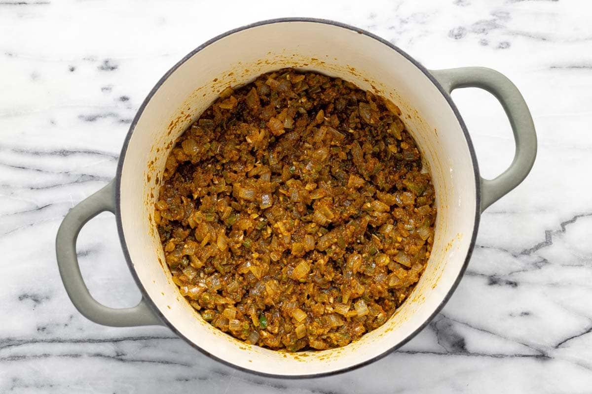 Sauteed veggies with spices in a large pot. 