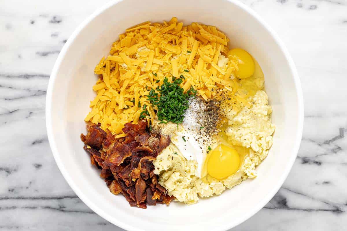 Bowl of ingredients to make mashed potato muffins. 