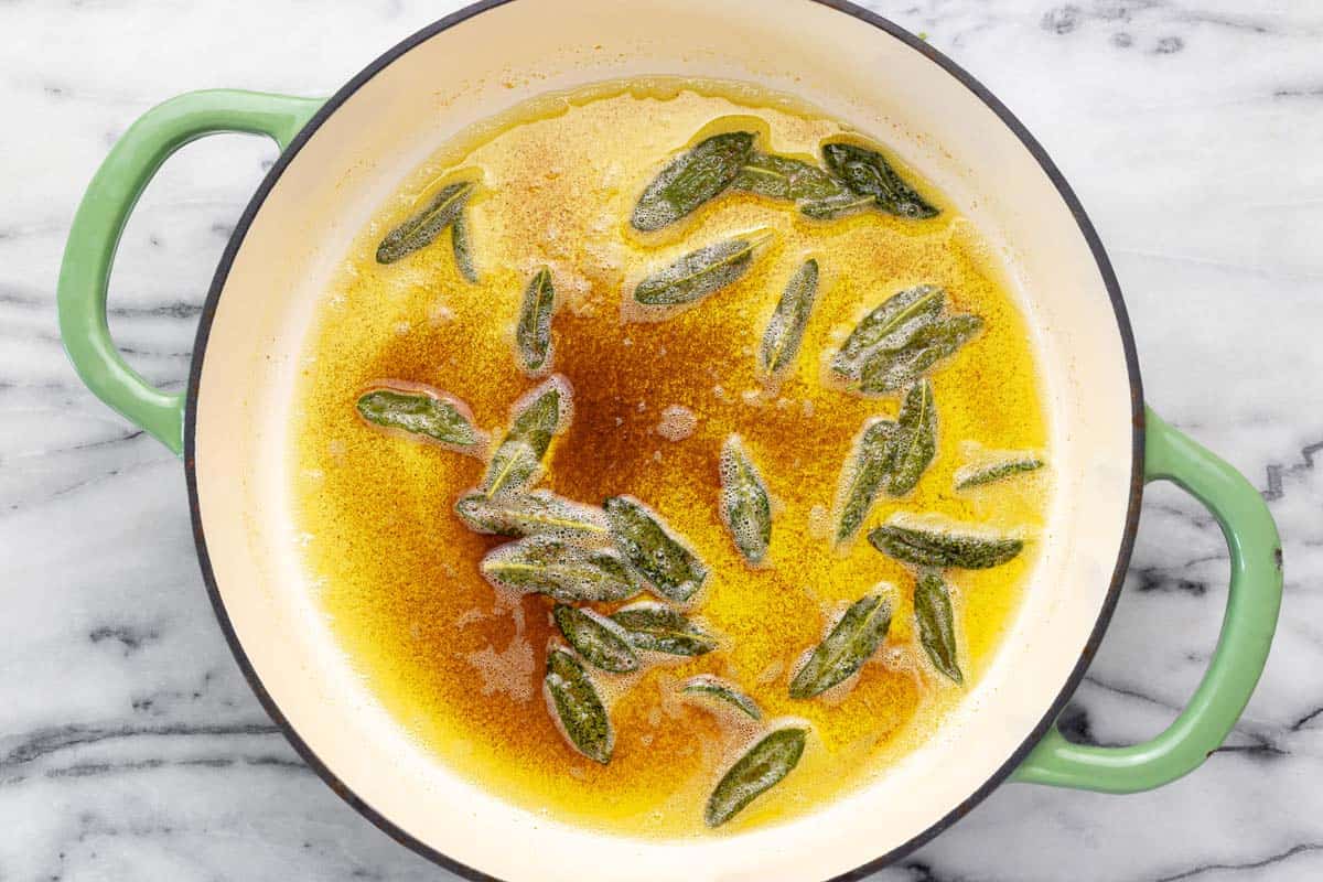Large pan with sage brown butter in it. 