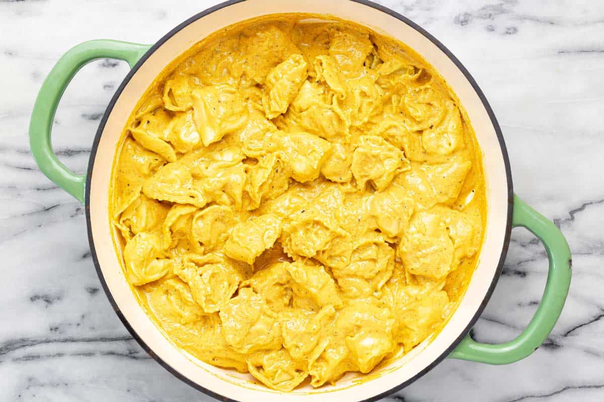 Large pan filled with tortellini tossed in creamy pumpkin sauce. 