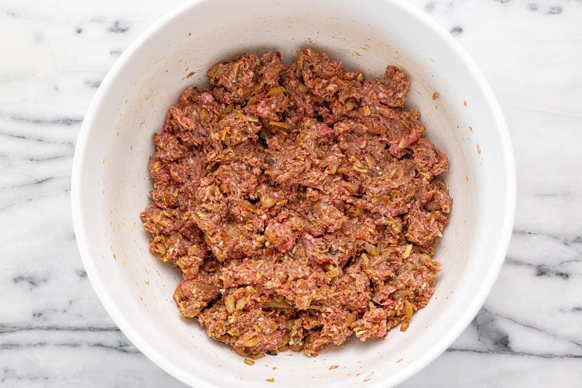 Bowl filled with French onion meatball mixture.