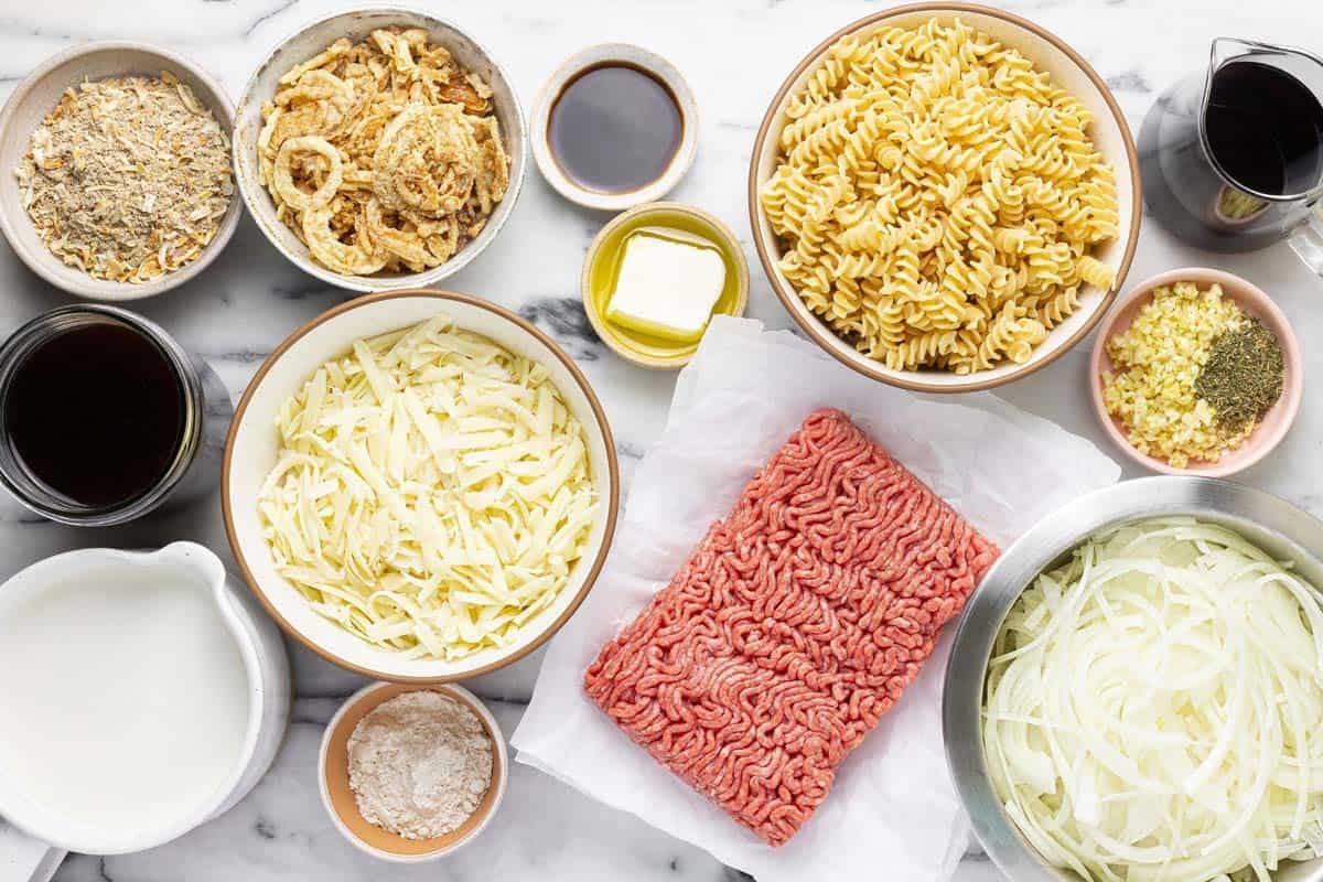 Bowls of ingredients to make French onion pasta.
