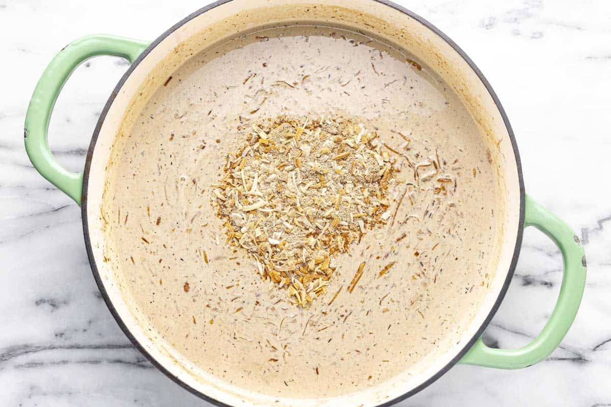 Creamy French onion pasta sauce in a large pan.