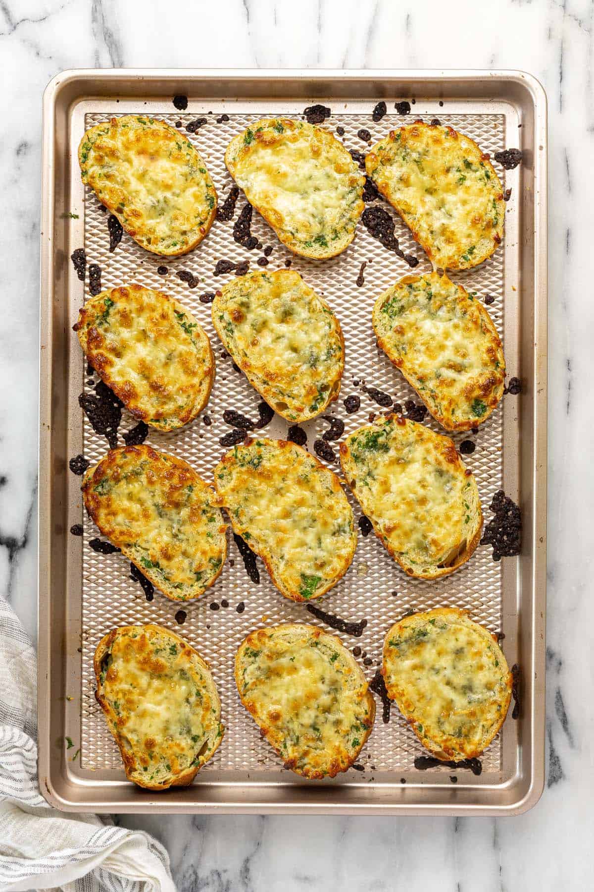 Baking sheet with freshly baked garlic cheese bread.