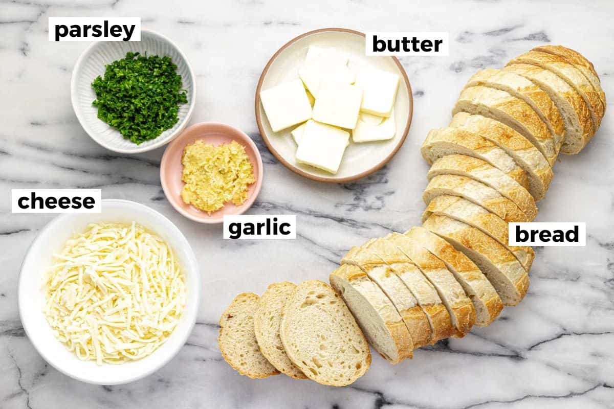 Bowls of ingredients to make garlic cheese bread.