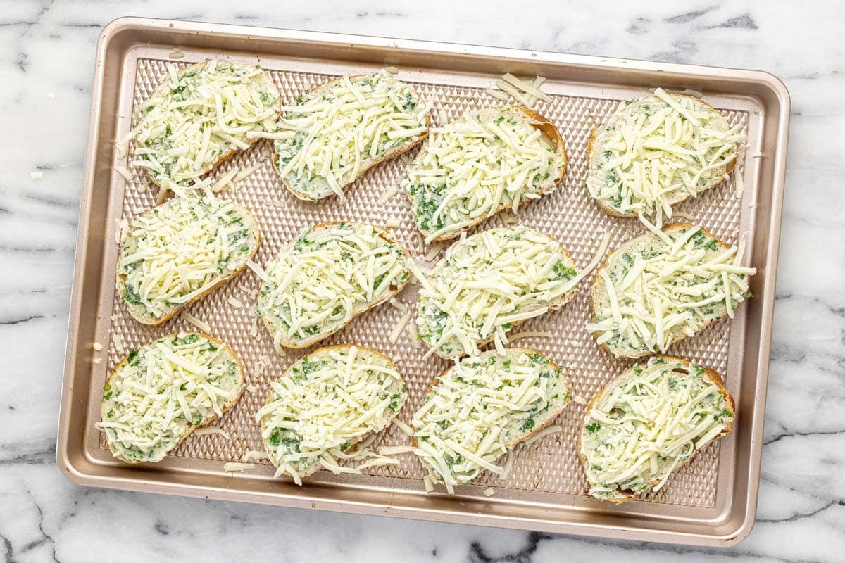 Sliced garlic cheese bread with shredded cheese on top.