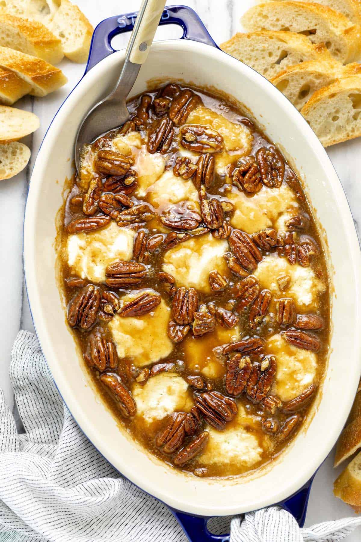 Baking dish filled with pecan pie baked goat cheese dip.
