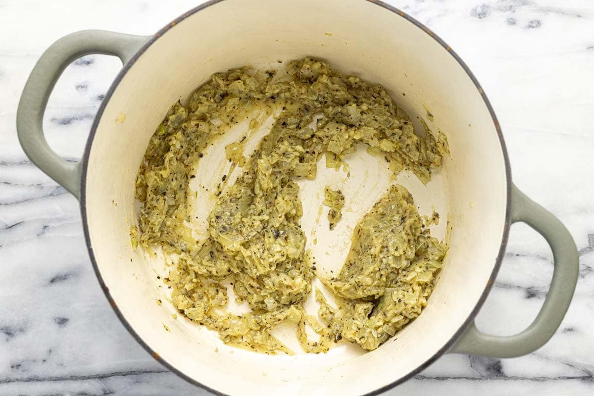 Creamy roux and sauteed veggies in a large pot.