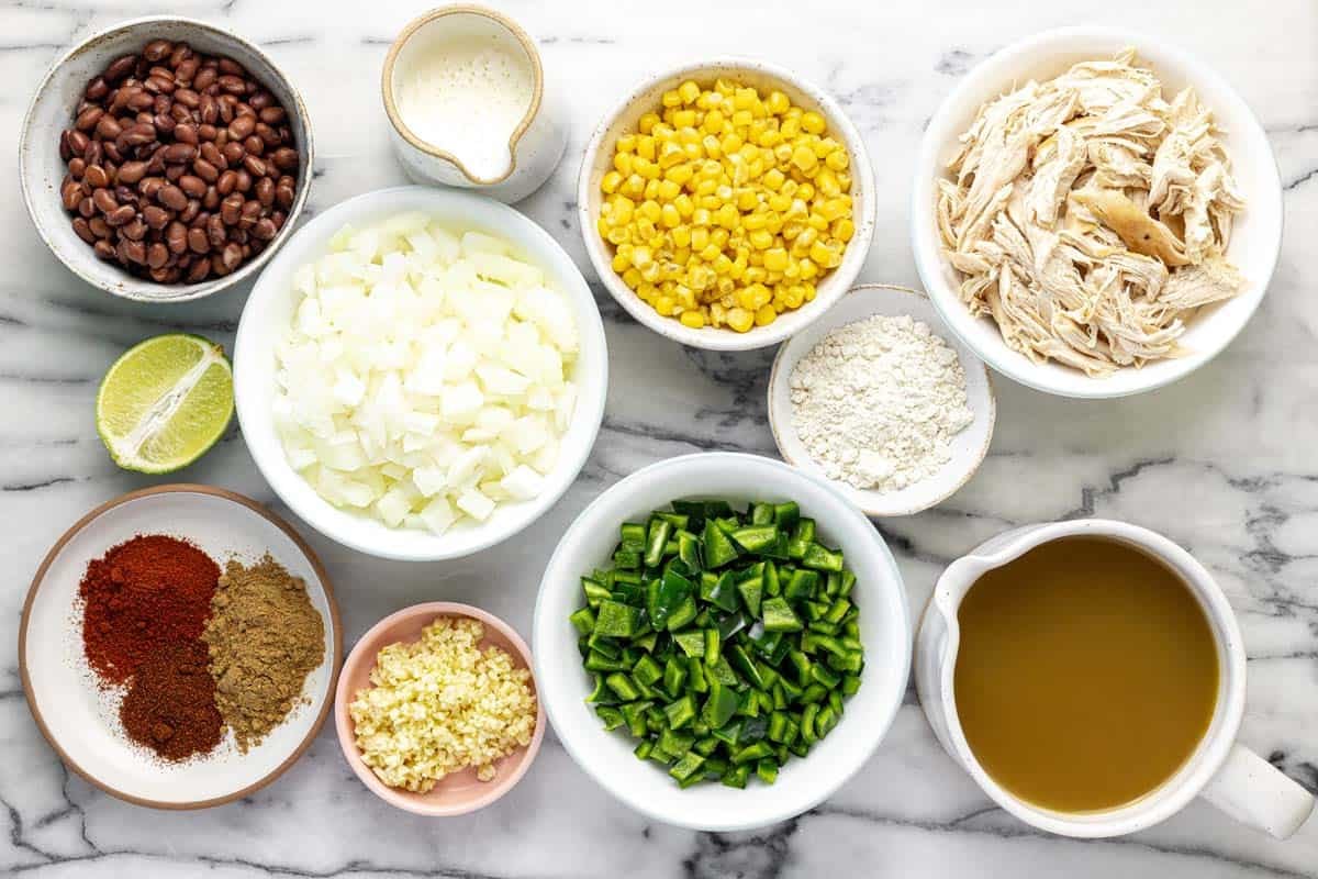 Bowls of ingredients to make creamy chicken poblano soup.