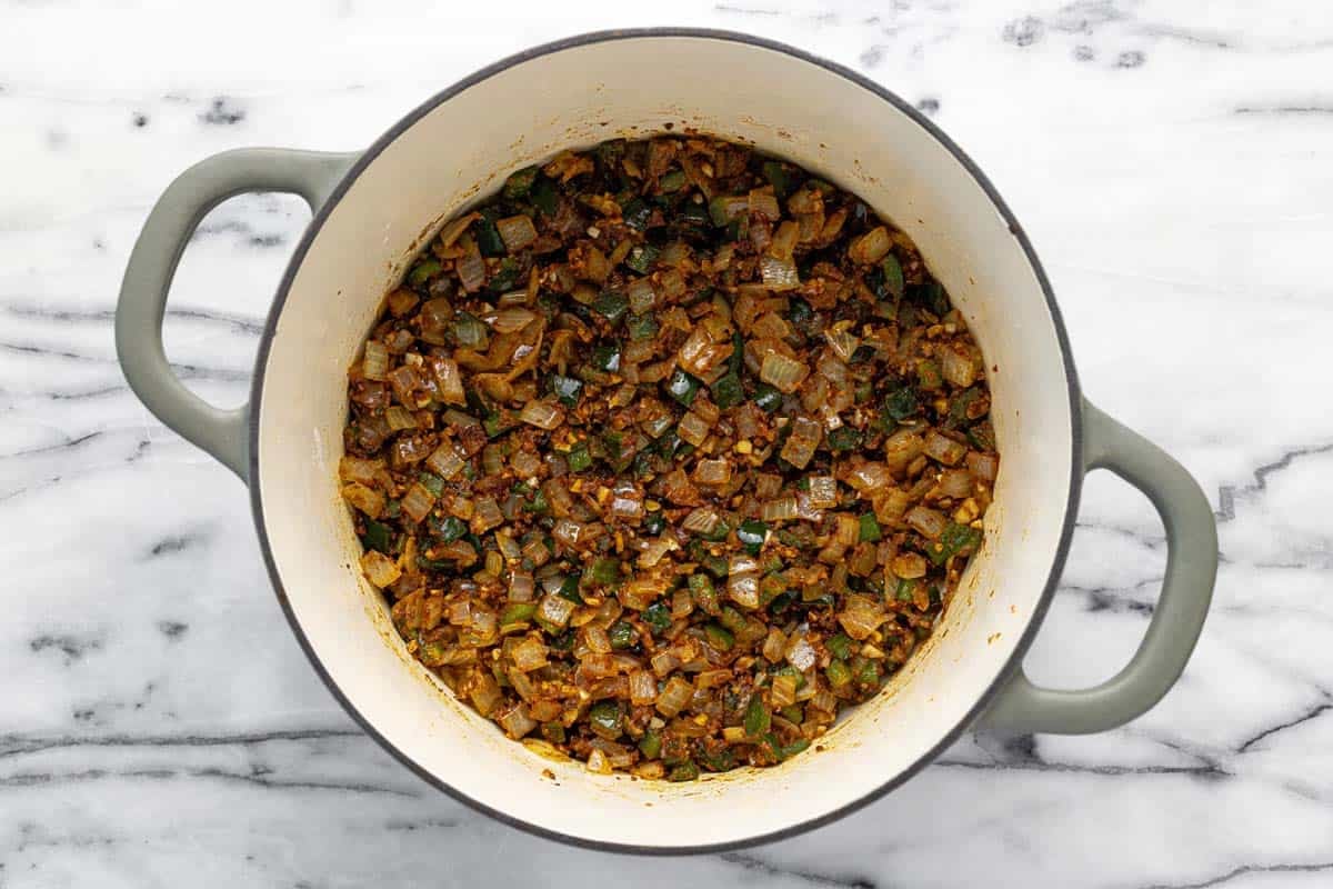 Diced veggies and spices in a large pot.