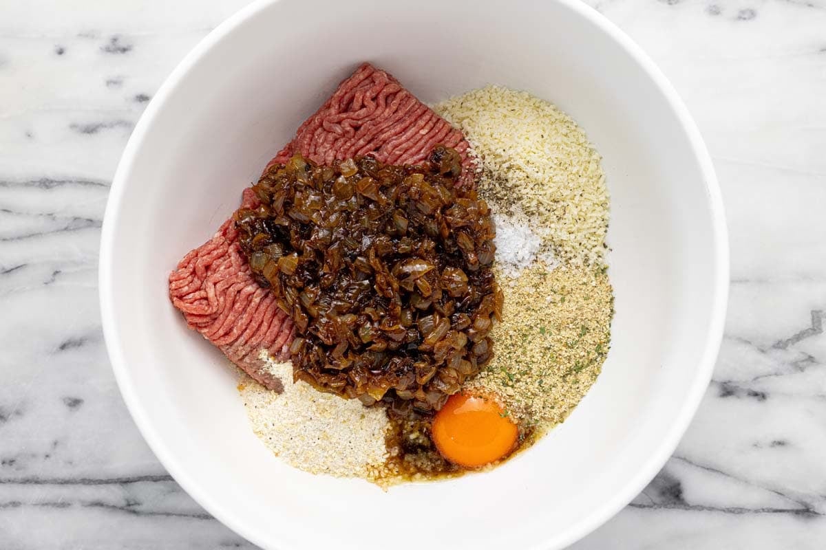 Large bowl filled with meatloaf ingredients.