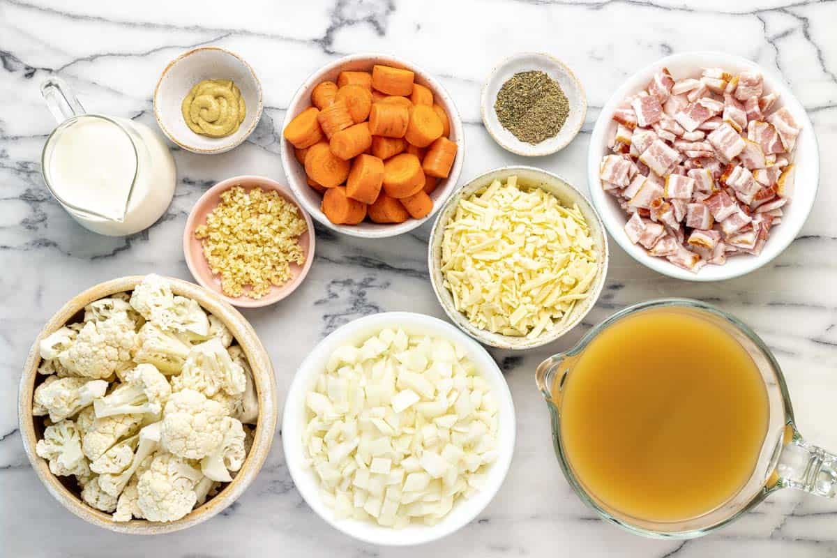 Bowls of ingredients to make creamy cauliflower soup.