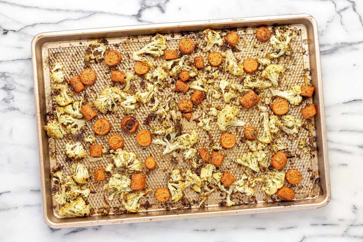 Large baking sheet with roasted cauliflower and carrots.