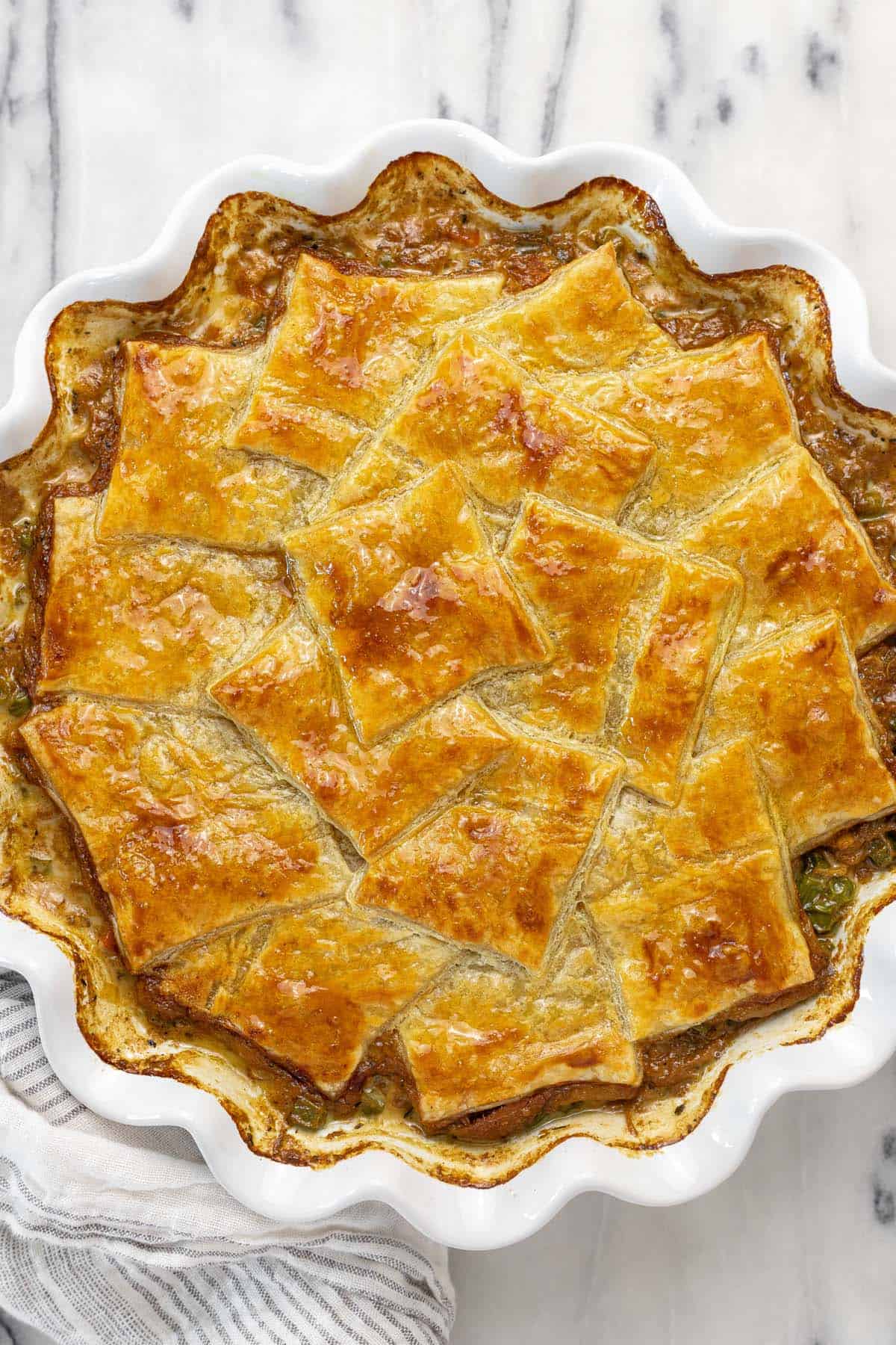 French onion chicken pot pie with golden puff pastry.