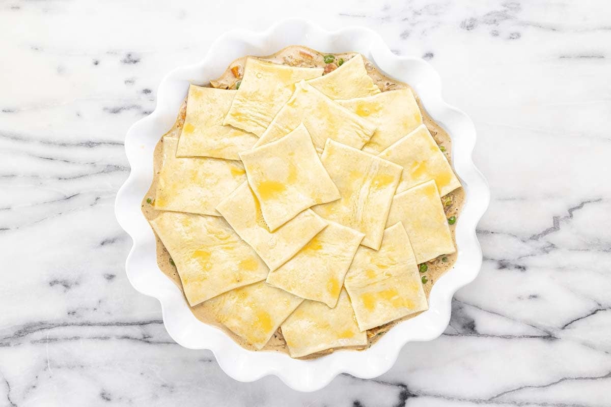 French onion chicken pot pie topped with puff pastry brushed with egg.