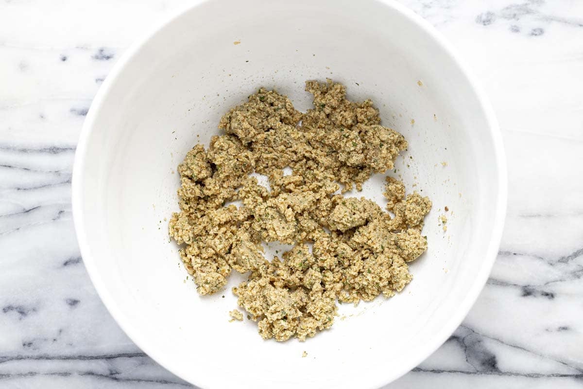 A mixture of breadcrumbs and milk in a large bowl.