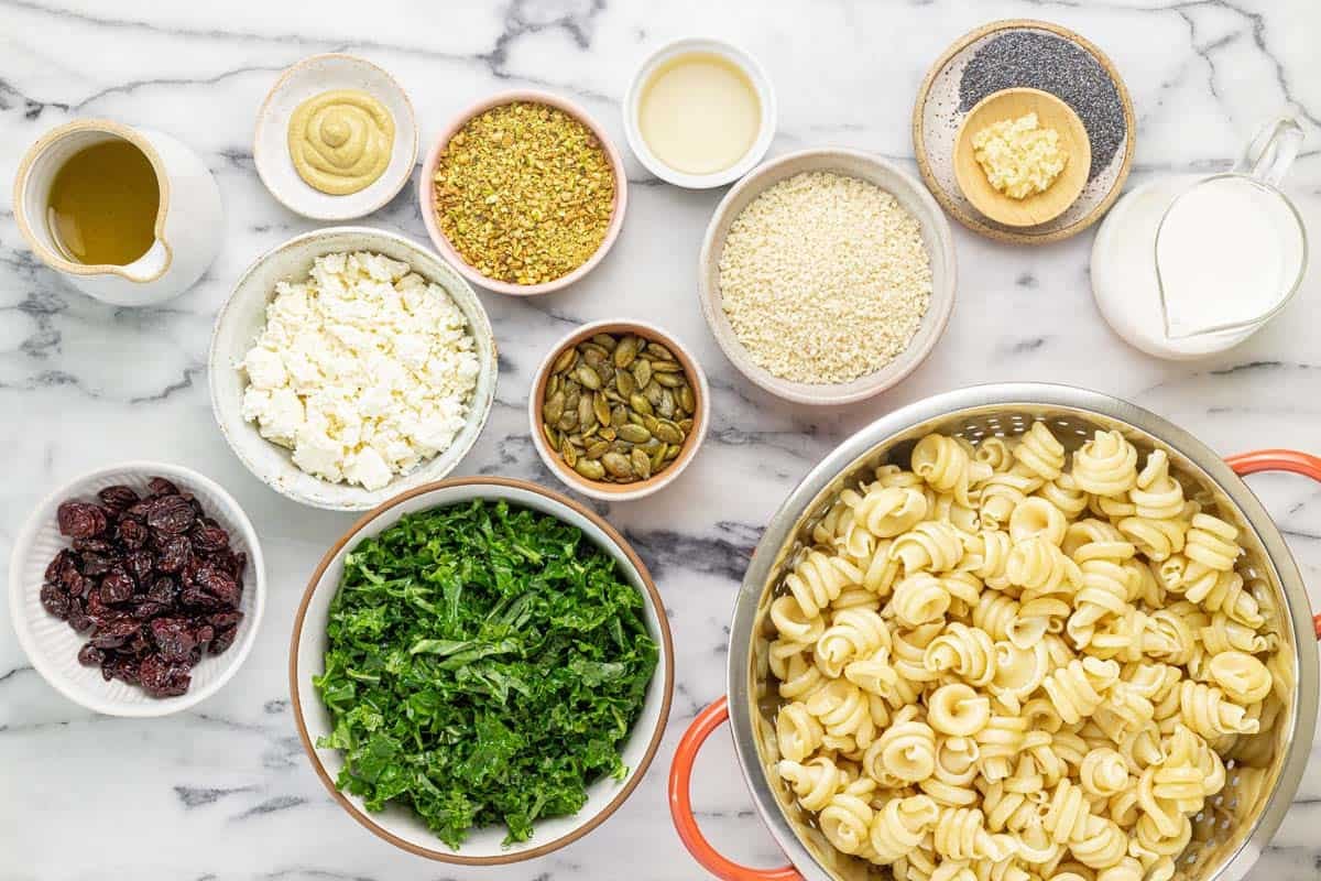 Bowls of ingredients to make winter pasta salad.
