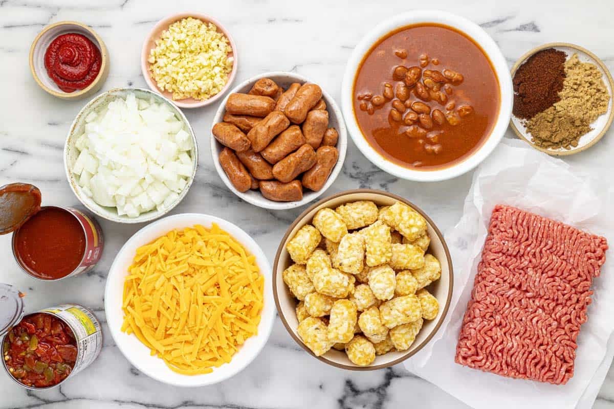 Bowls of ingredients to make chili cheese dog tater tot casserole.