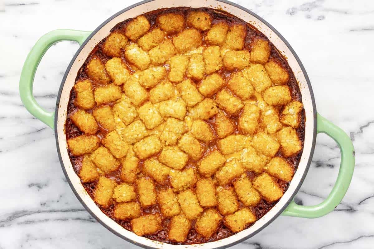 Freshly baked chili cheese dog tater tot hot dish in a pan.