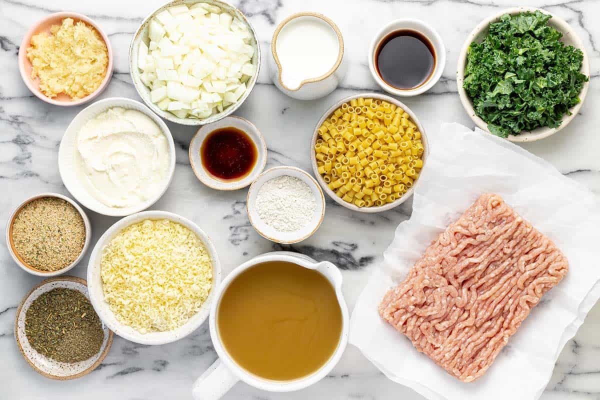 Bowls of ingredients to make chicken meatball soup.