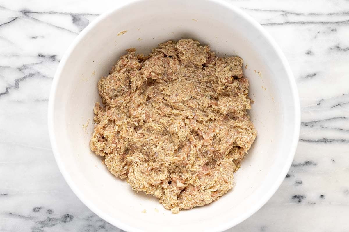 Bowl filled with chicken meatball mixture.